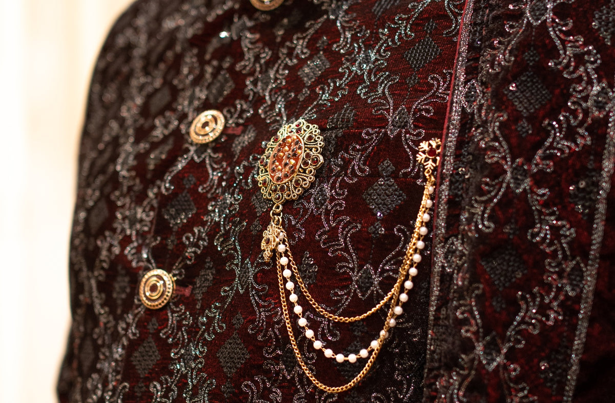 Dark embroidered sherwani with gold buttons